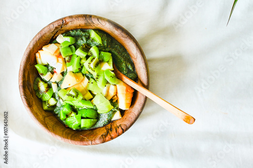 Green smoothies bowl with apple and kiwi, healthy raw breakfast