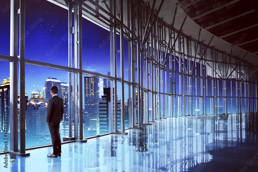 Successful manager looking the city from his office Successful manager looking the city from his office