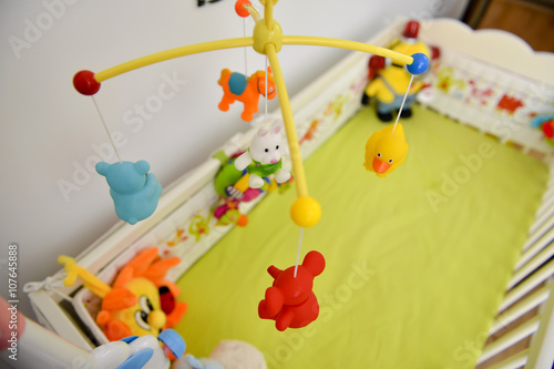 Baby cot with colorful toys hanging