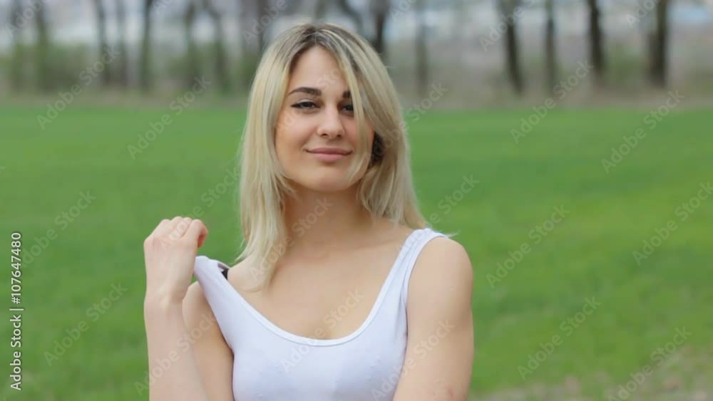 Seductive girl in white shirt in the garden. Slow motion