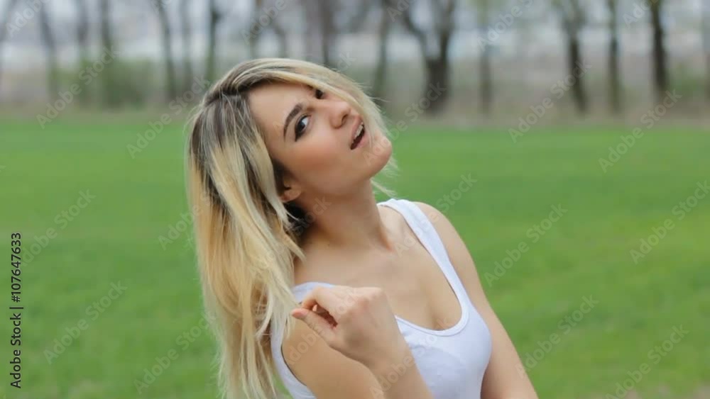 Smiling Attractive girl at the garden Looking Over her Shoulder at the Camera. Smiling Attractive girl at the garden Looking Over her Shoulder at the Camera.