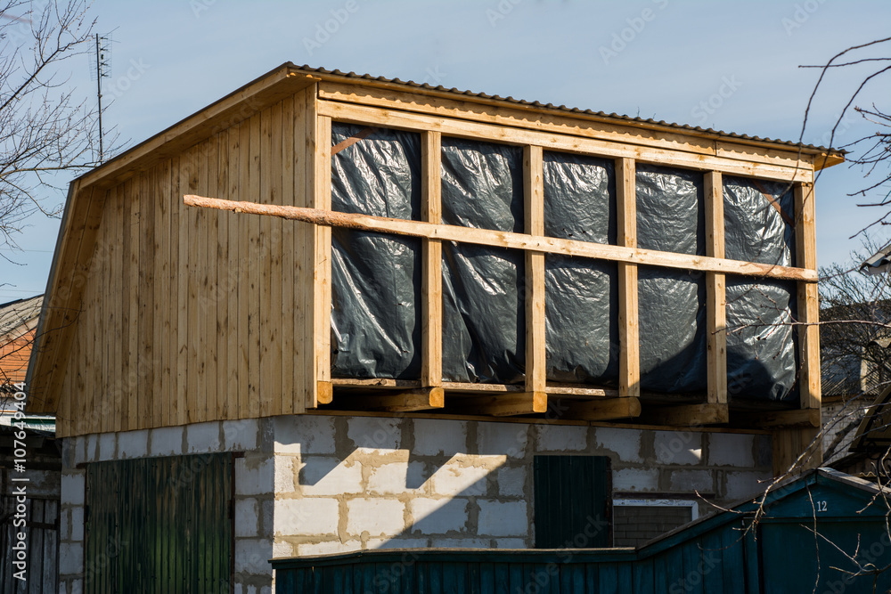 Obraz premium Building second floor extension on garage with water protective barrier