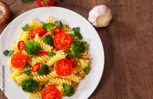 Wallpaper Mural Fusilli pasta with cherry tomatoes and broccoli in a plate on wooden table Torontodigital.ca
