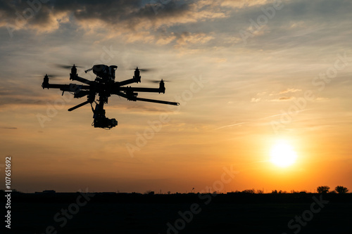 Professional drone flying in the sunset