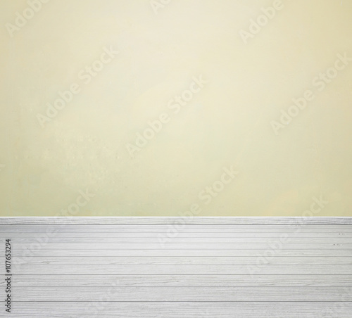 room interior with yellow concrete wall and white wood floor