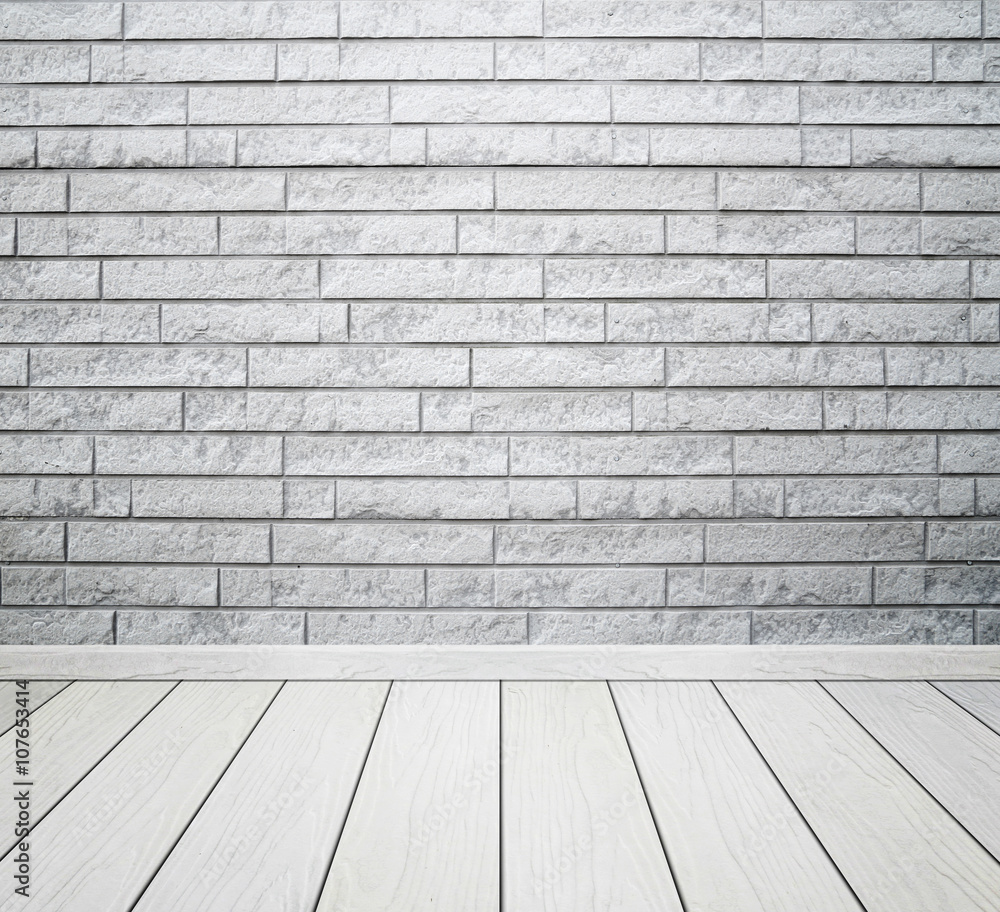 white room interior with brick wall and wood floor