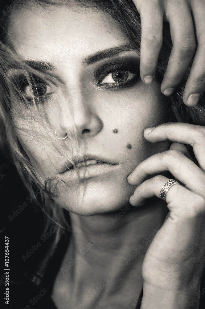 Obraz premium Close-up black and white portrait of beautiful stylish girl model with trendy make-up smoky eyes