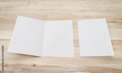 Bifold white template paper on wood texture