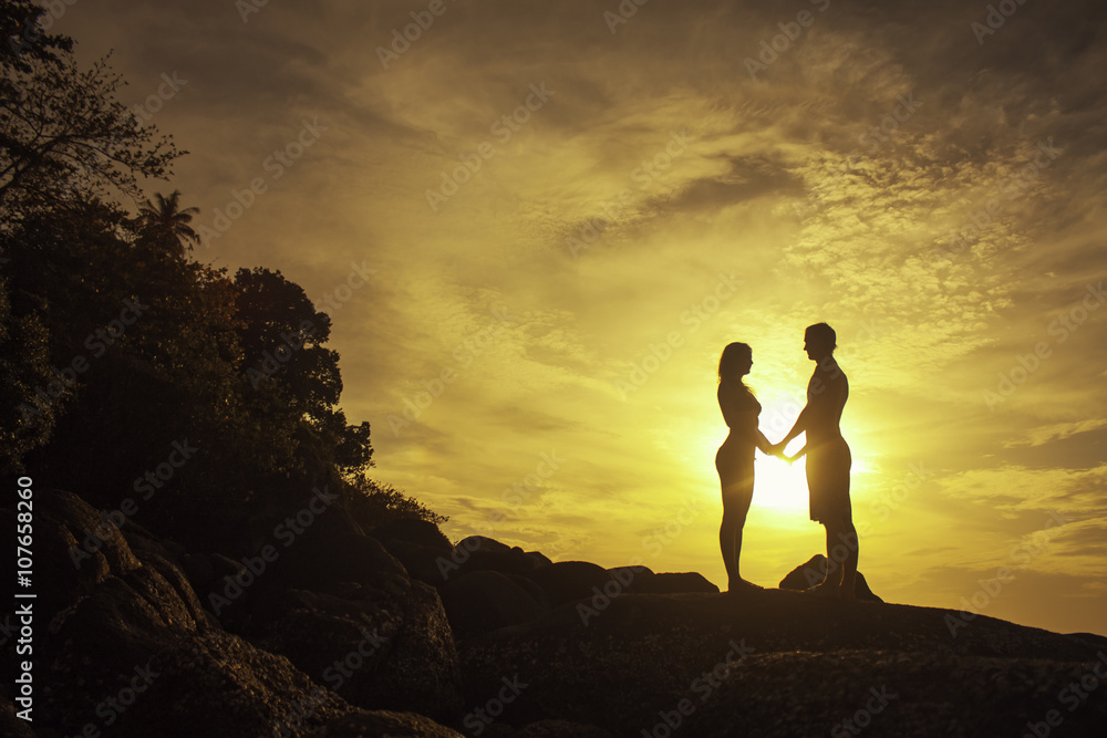Romantic silhouette of loving couple on beautiful red sky sunset
