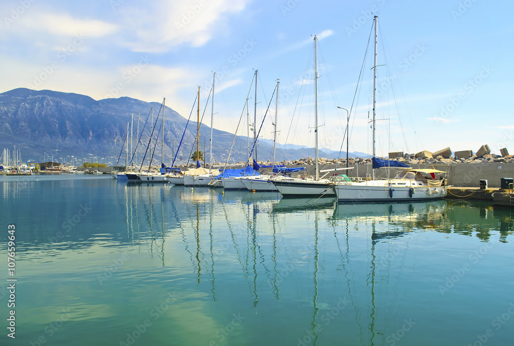 sailboats reflected on sea at Kalamata harbor Peloponnese Greece