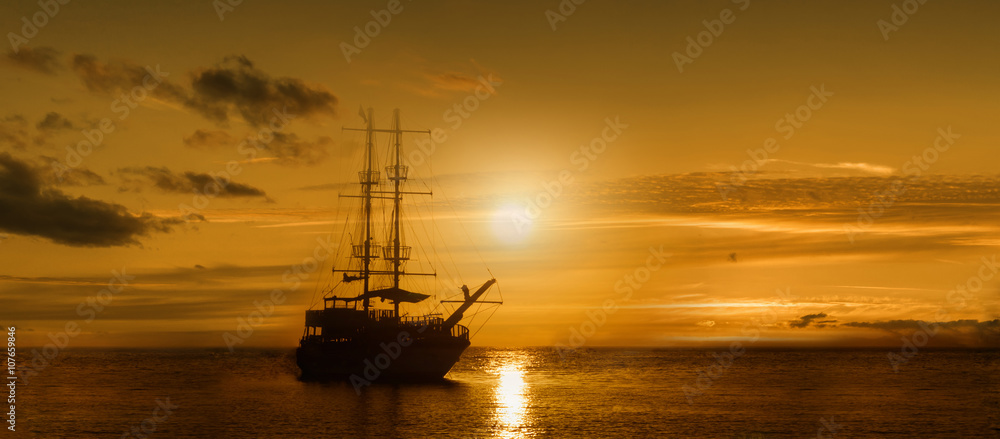 Panoramic image of the ship on a sunset background