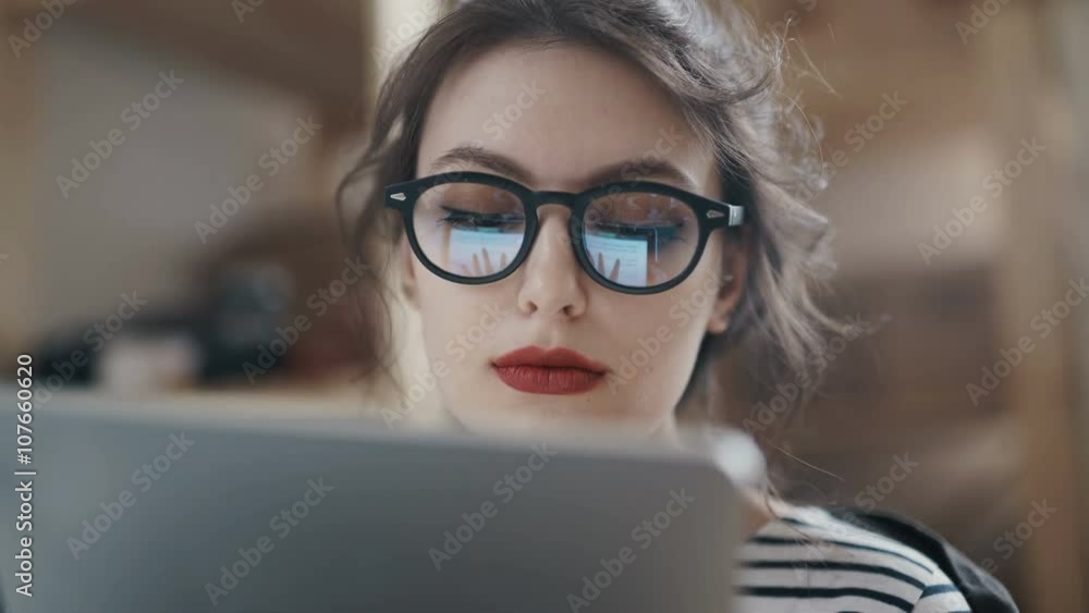Stylish brunette working from home in her home office Stylish brunette working from home in her home office