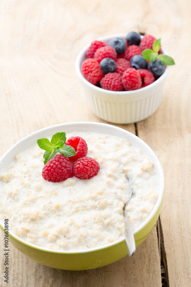 Oatmeal porridge in bowl with berries raspberries and blackberri Oatmeal porridge in bowl with berries raspberries and blackberri