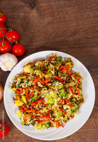 Mixed vegetables with rice in a plate on wooden table