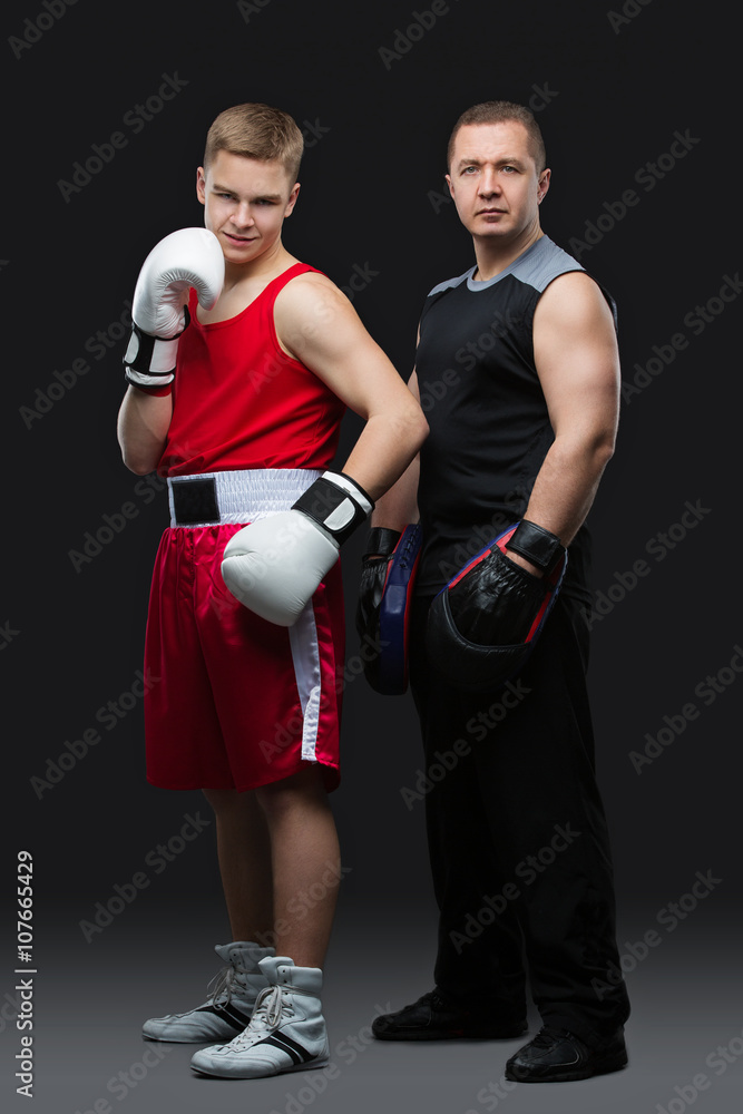 Young boxer with trainer