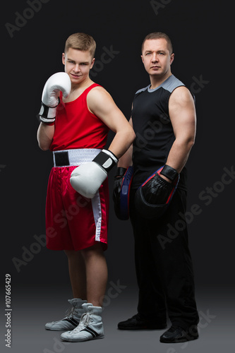 Young boxer with trainer