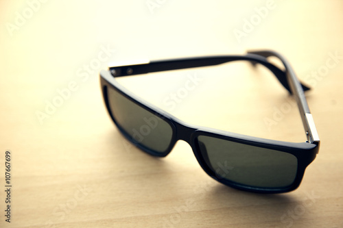 sun-glasses on wooden table