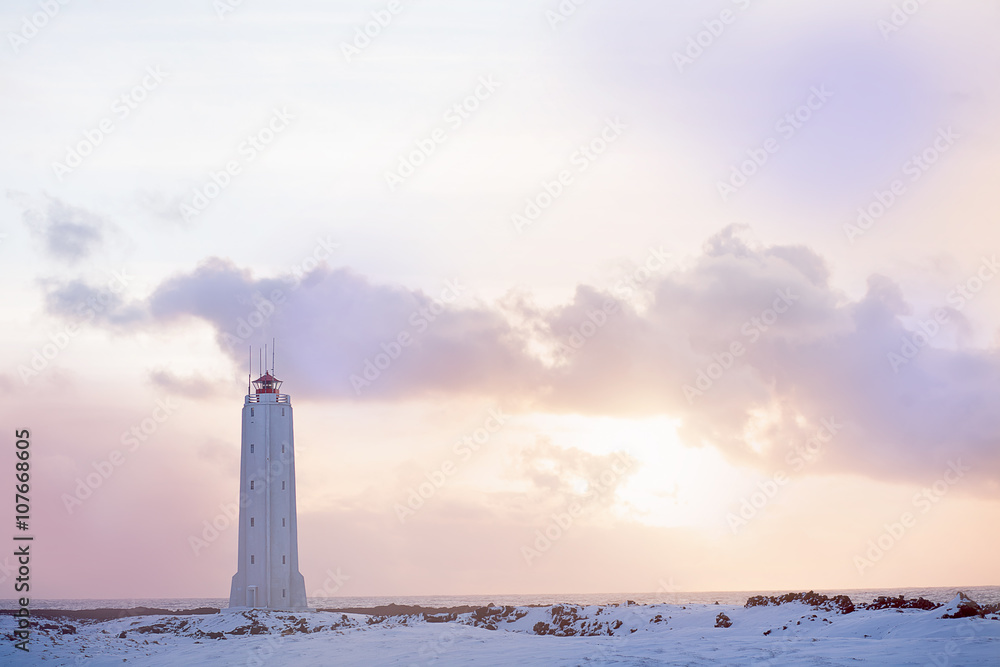 Beacon on the coast of the Atlantic Ocean in Iceland at sunset in the winter