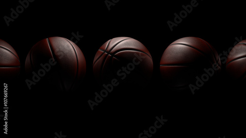 Five Basketballs on black background. Clipping Path.