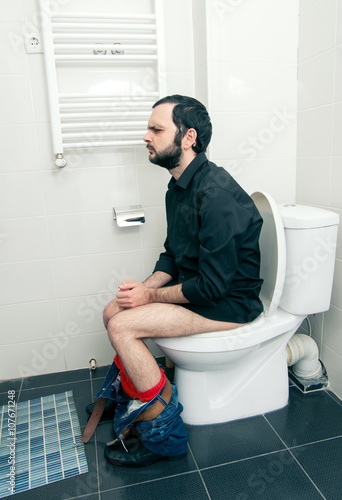 man having problems in the toilet