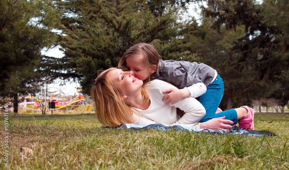 mother with daughter having fun in park mother with daughter having fun in park