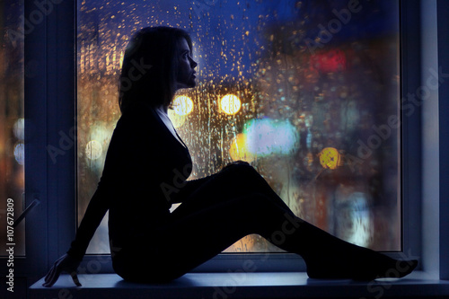 Photography girl night lights of the city window