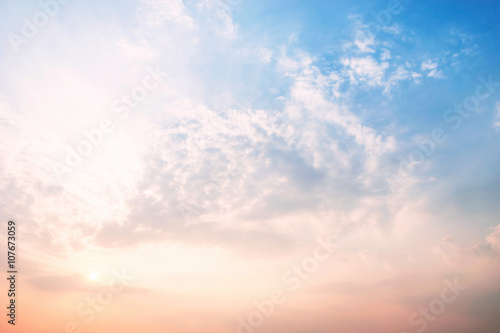 Sky blue and orange light of the sun through the clouds in the s