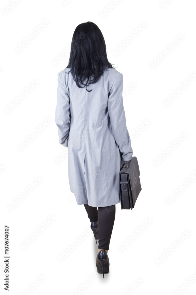 Businesswoman with briefcase walks in studio Businesswoman with briefcase walks in studio