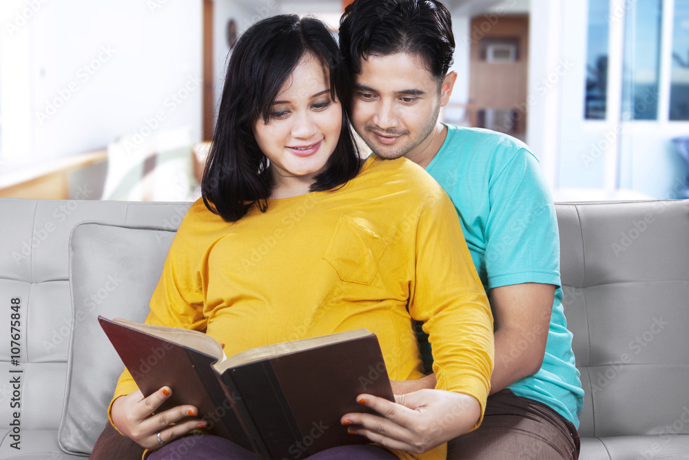 Happy family reading a book Happy family reading a book