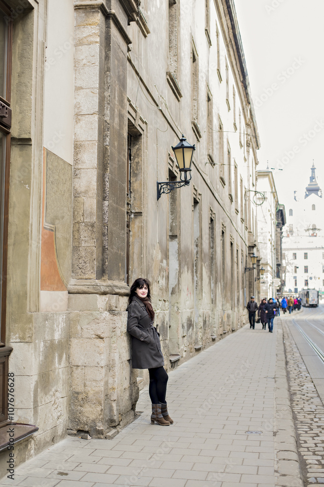 Lonely girl in a gray coat