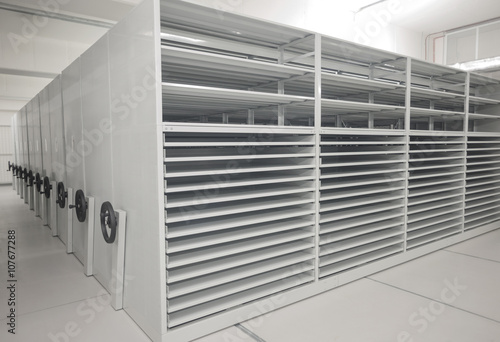 Canvas-taulu Art history museum depository warehouse archive with empty grey shelves and storage space