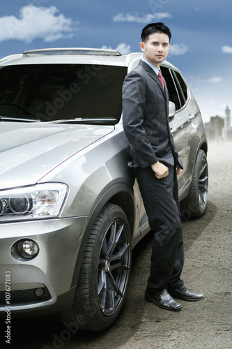 Successful entrepreneur and new luxury car © Creativa Images