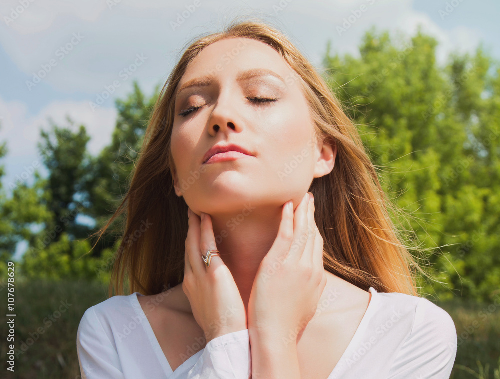 Close up portrait of young woman in white dress outdoor in nature, meditating Close up portrait of young woman in white dress outdoor in nature, meditating