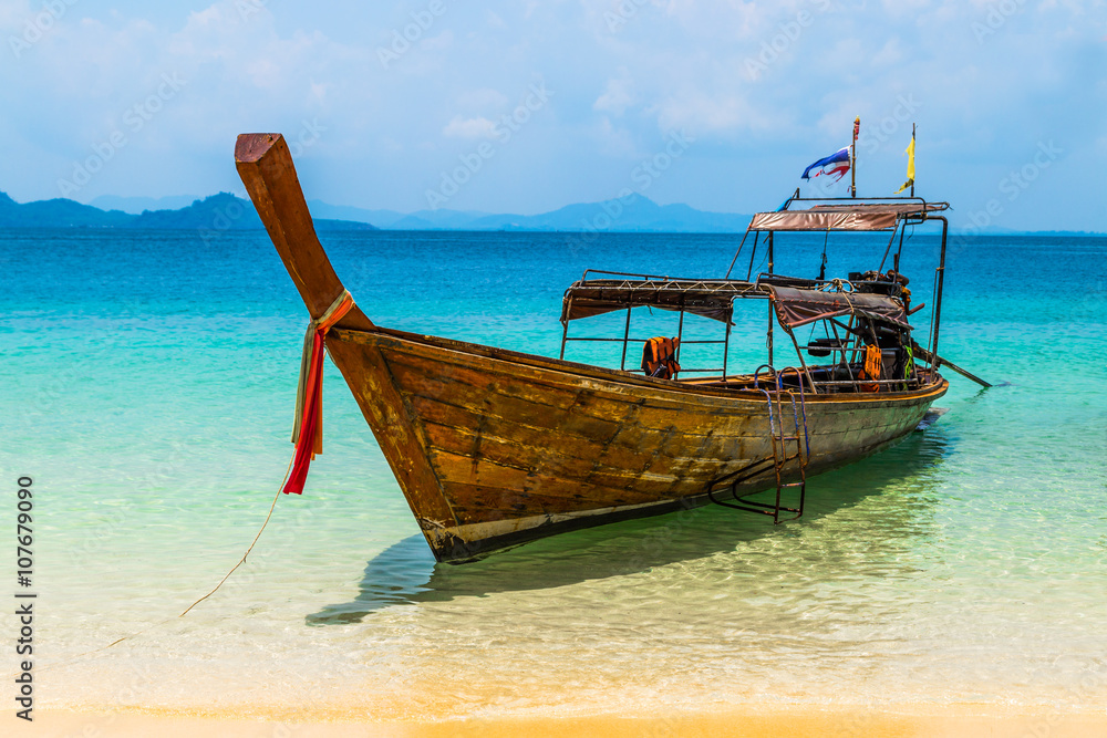 Fisherman wooden boat on sea coast with turquoise water Fisherman wooden boat on sea coast with turquoise water