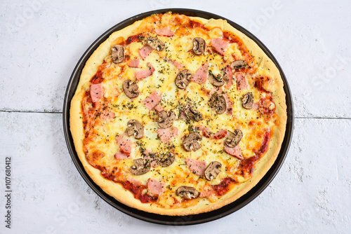 Delicious pizza with mushrooms and ham.