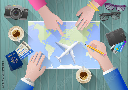 young couple travel plans aim to honeymoon on the world map. view from above. are on the table glasses, camera, plane tickets, wallet, passport, and the layout of the aircraft