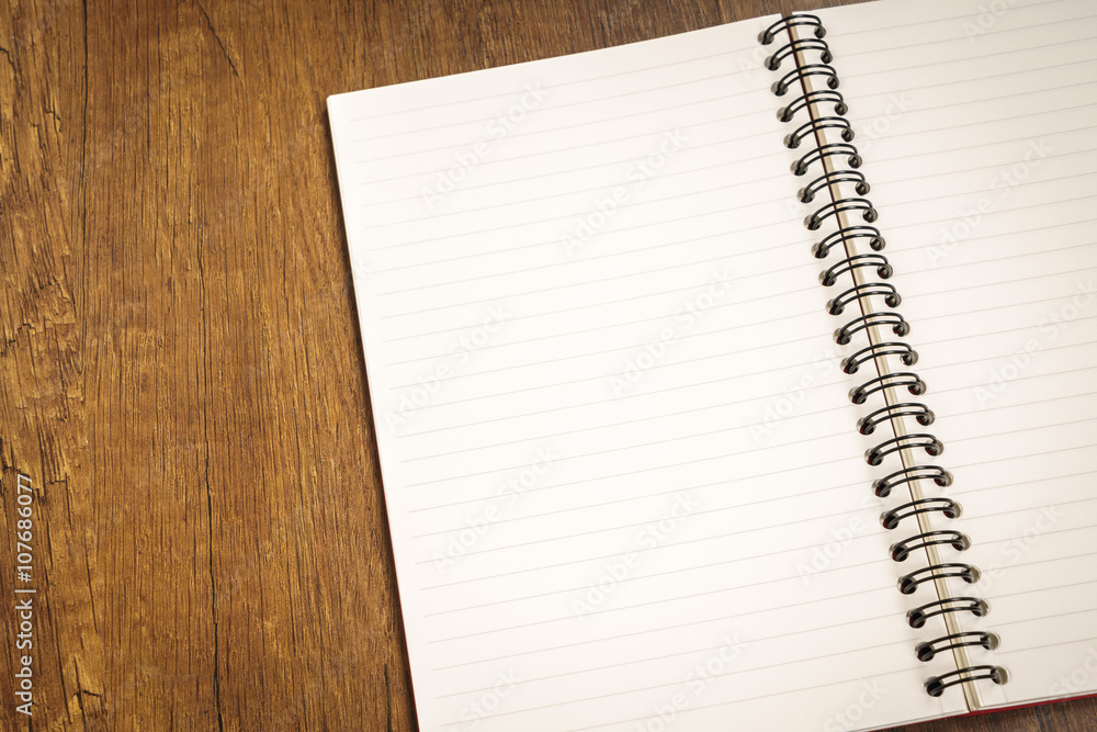 Note book on a wooden desk Note book on a wooden desk