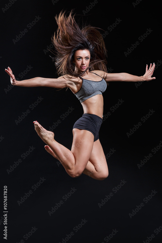 beautiful fitness female posing on studio background