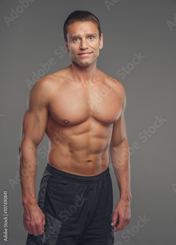 Shirtless muscular middle age man.