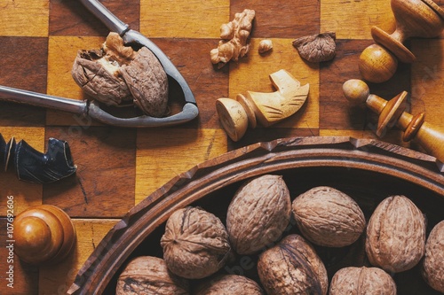 Autumn mood. Chess and walnuts. Food and games concept.