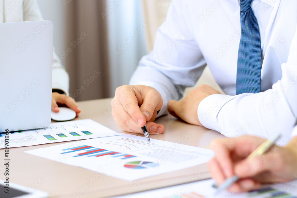 Business colleagues working and analyzing financial figures on a Business colleagues working and analyzing financial figures on a