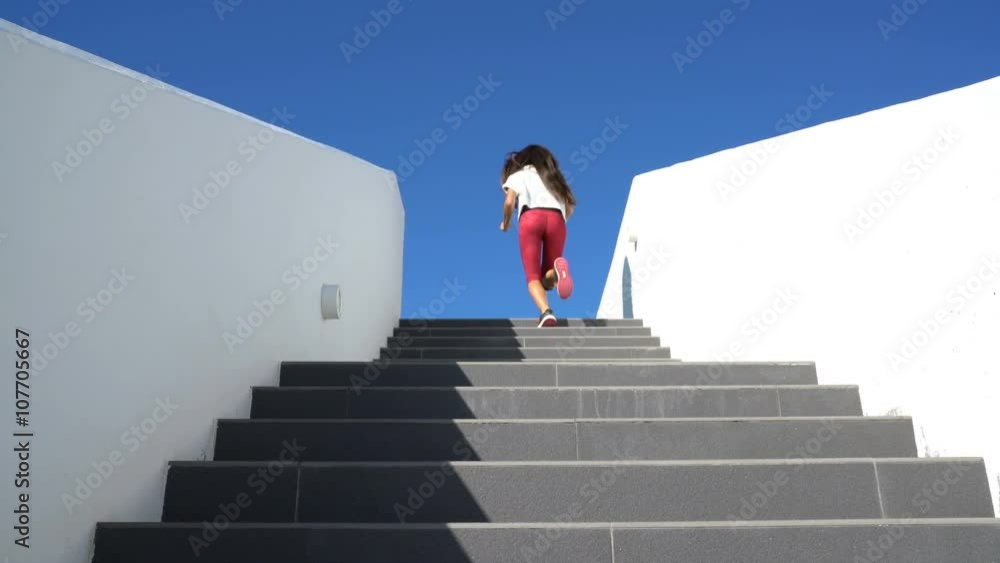 Stairs running woman doing run up steps on staircase. Female runner athlete climbing stairs in sport workout run outside. Stairs running woman doing run up steps on staircase. Female runner athlete climbing stairs in sport workout run outside.