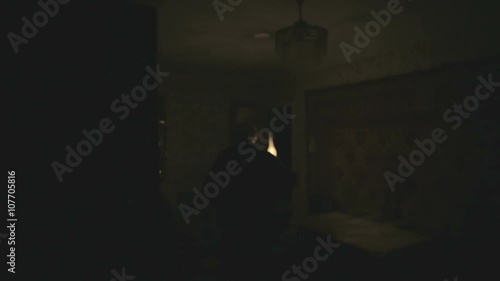 Old grandpa is a dark room with a kerosene lamp. Scary ghost in the night. photo