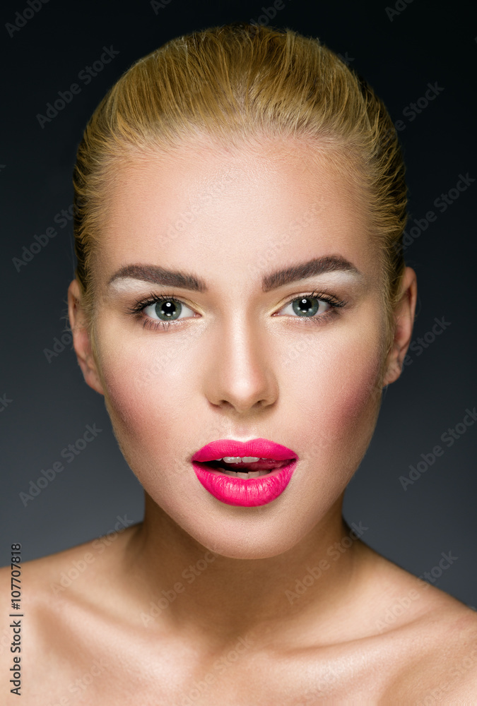 Beautiful blonde with colorful pink lips looking at the camera Beautiful blonde with colorful pink lips looking at the camera