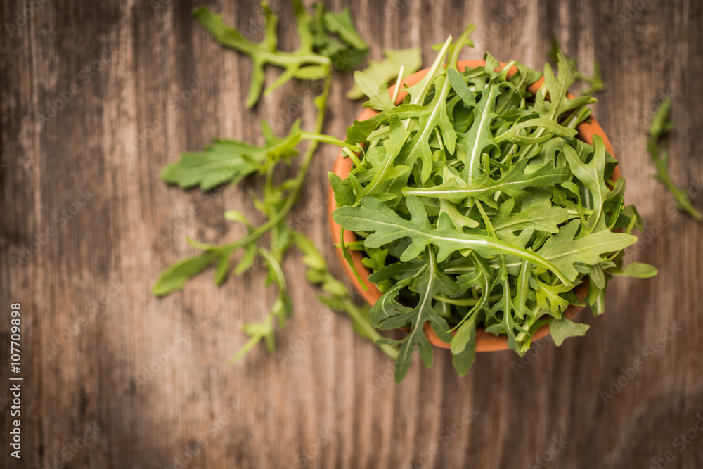 Fresh juicy arugula on wooden background and copy space Fresh juicy arugula on wooden background and copy space