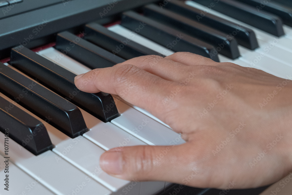Fototapeta premium Hand playing piano
