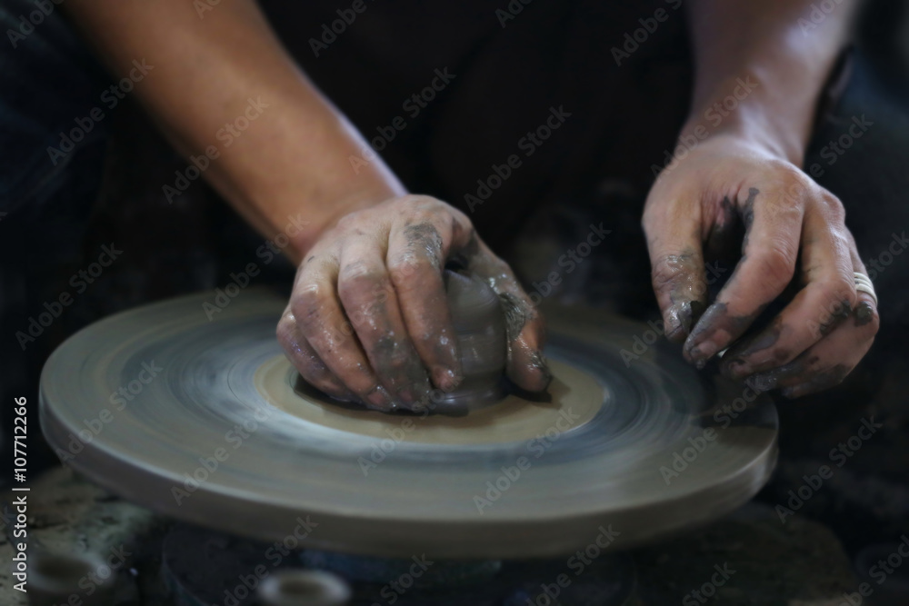 Hands working on pottery wheel Hands working on pottery wheel