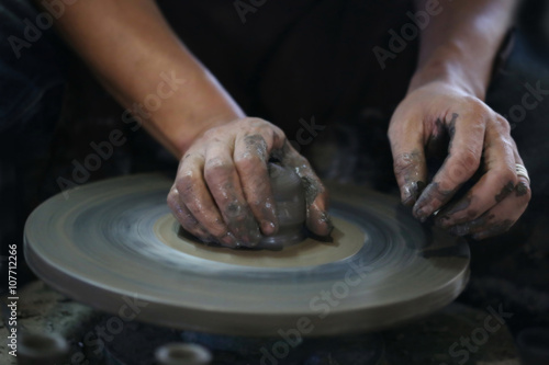 Hands working on pottery wheel