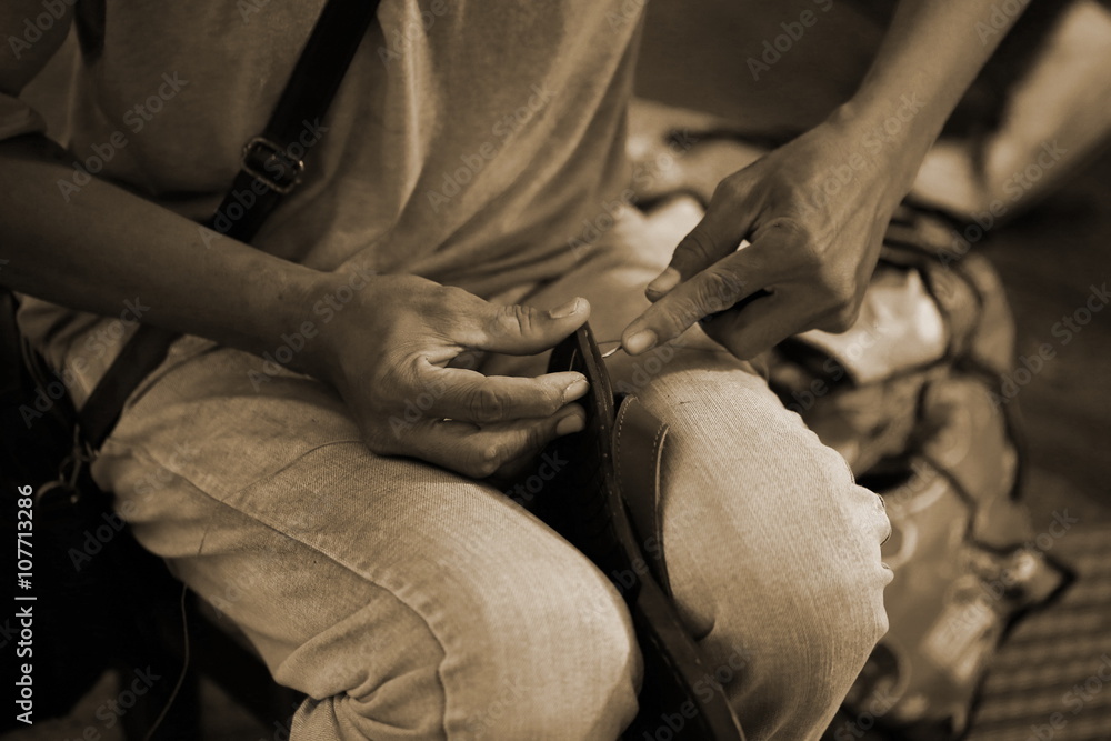 man hand sewing shoe man hand sewing shoe
