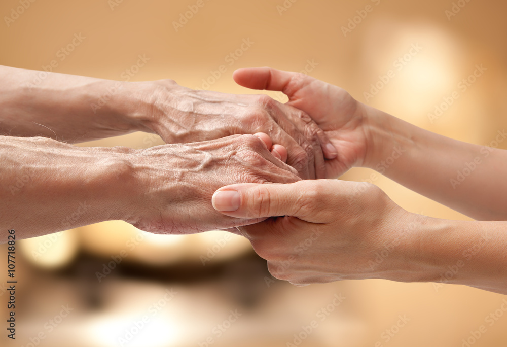 Female hands touching old male hand Female hands touching old male hand
